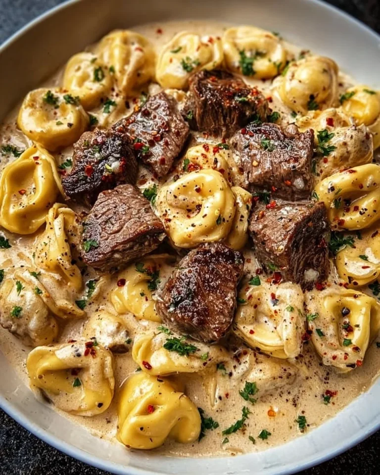 Cracked garlic steak tortellini in a creamy sauce served in a bowl