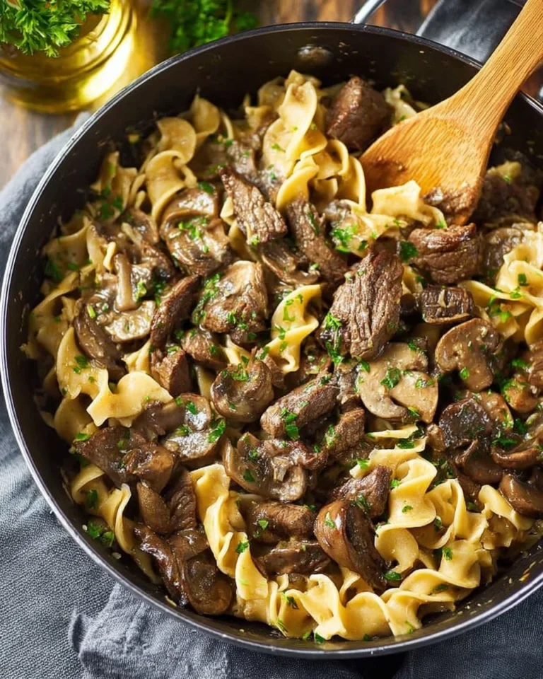 Delicious one pot beef stroganoff topped with fresh parsley in a skillet