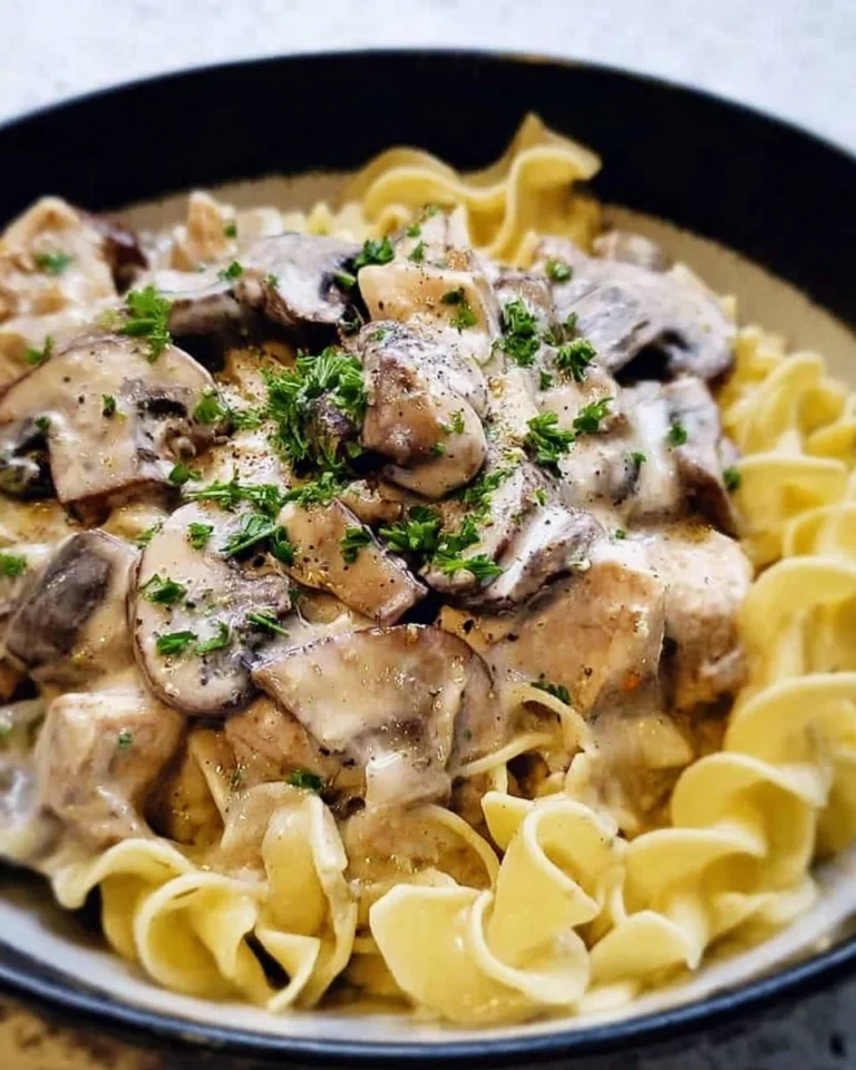 Delicious slow cooker chicken stroganoff with mushrooms served over noodles